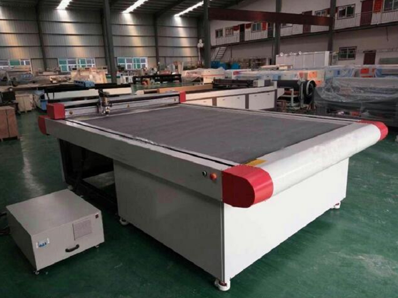 Industrial flatbed cutting machine in a manufacturing facility